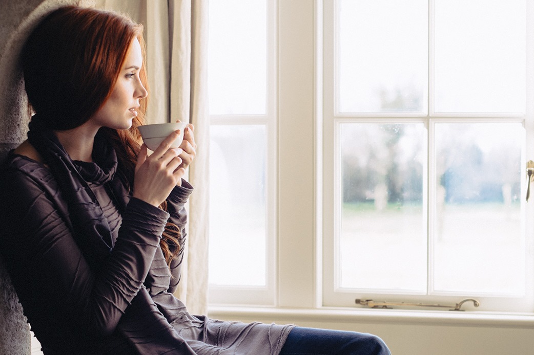 woman-looking-out-the-window-young